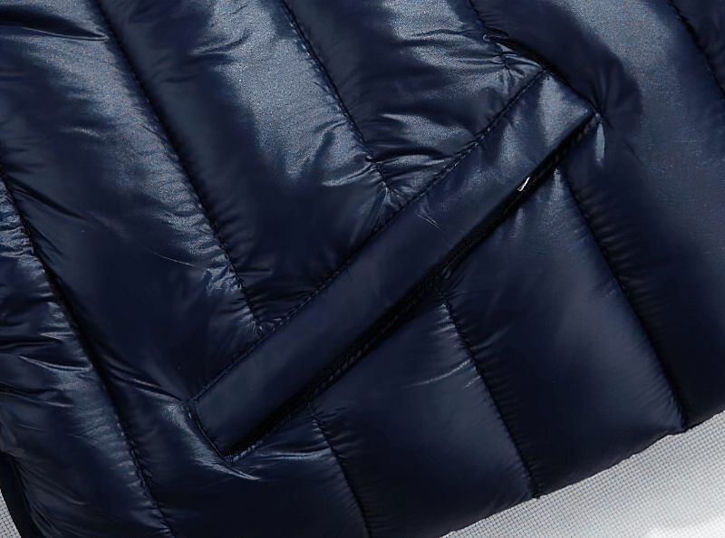 Close-up of a navy zipper on a women's thermal vest, featuring a quilted texture and sleek design.